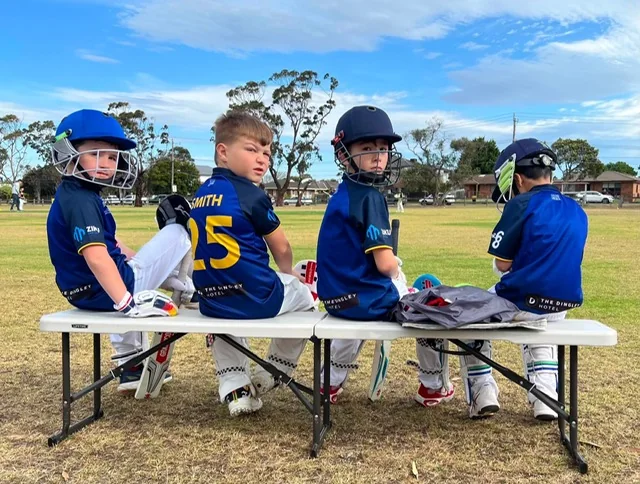 Dingley junior players on the bench during a match