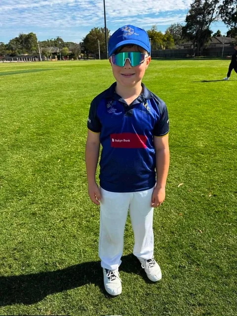 Young Dingley cricket player in cap and sunglasses